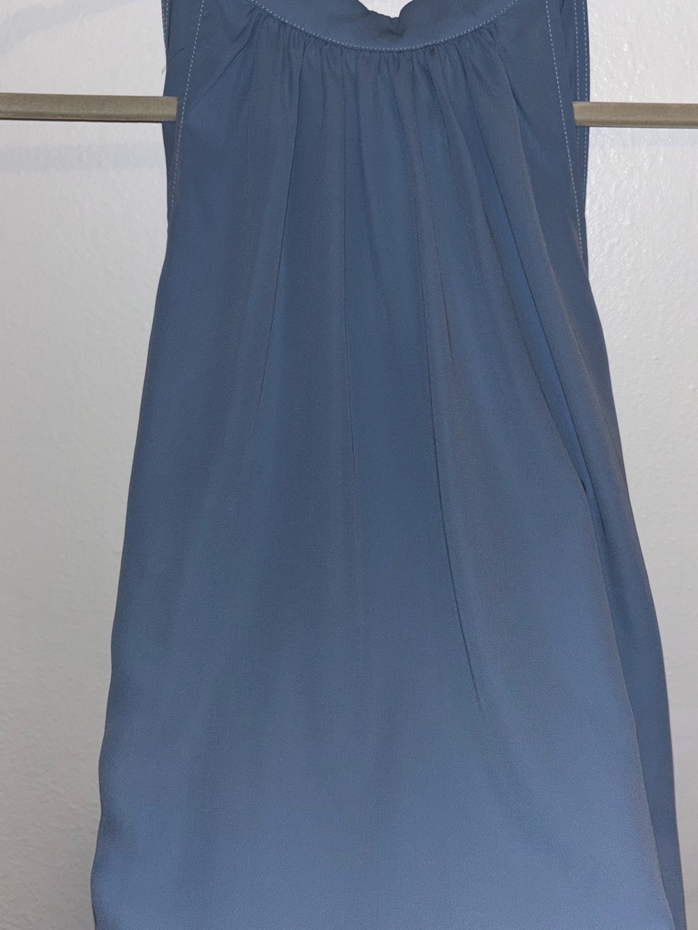 Sleeveless Blue Halara blouse, high neck and keyhole back.